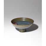 A CHINESE JUN YAO STEM BOWL YUAN/MING DYNASTY The shallow bowl raised upon a flaring foot, decorated