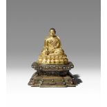 A TIBETAN GILT-BRONZE PORTRAIT OF A LAMA C.13TH CENTURY Cast seated in dhyanasana upon a gilded