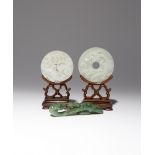 TWO CHINESE WHITE JADE BI AND A SPINACH-GREEN JADE BELTHOOK 18TH/19TH CENTURY One bi disc carved