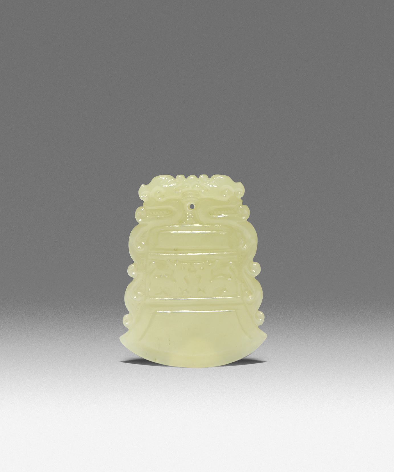 A RARE CHINESE YELLOW JADE PENDANT QIANLONG 1736-95 Carved in the shape of a bell, decorated in