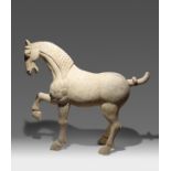 A LARGE CHINESE POTTERY MODEL OF A HORSE TANG DYNASTY The horse depicted standing proud on three