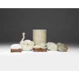 A GROUP OF SEVEN CHINESE JADE ITEMS 18TH/19TH CENTURY Comprising: a pale celadon carving of a cat, a