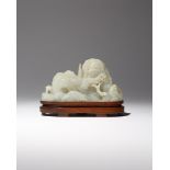 A CHINESE CELADON JADE 'MOUNTAIN' CARVING QIANLONG 1736-95 Formed as rounded craggy peaks, decorated