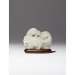 A CHINESE WHITE JADE CARVING OF TWO BADGERS QIANLONG 1736-95 One of the creatures depicted standing,