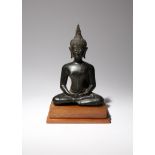 A THAI BRONZE FIGURE OF BUDDHA PROBABLY 15TH CENTURY Cast seated with crossed legs, his hands