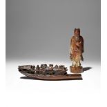 A CHINESE SOAPSTONE FIGURE AND A BAMBOO CARVING OF A SAMPAN 19TH/EARLY 20TH CENTURY The figure