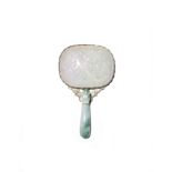 A CHINESE JADEITE BELTHOOK AND PLAQUE MOUNTED AS A HAND HELD MIRROR 19TH/EARLY 20TH CENTURY The