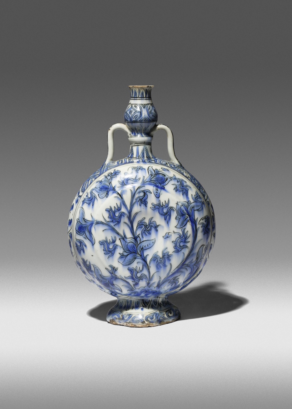 A RARE SAFAVID BLUE AND WHITE PILGRIM FLASK 17TH CENTURY The compressed body moulded to each