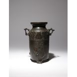 A CHINESE ARCHAISTIC BRONZE VASE MING DYNASTY The tall cylindrical body surmounted by a short