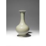 A CHINESE CELADON GLAZED 'LOTUS' BOTTLE VASE KANGXI 1662-1722 The compressed circular body rising