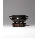 A CHINESE BRONZE TRIPOD INCENSE BURNER QING DYNASTY The compressed body raised on three tapering