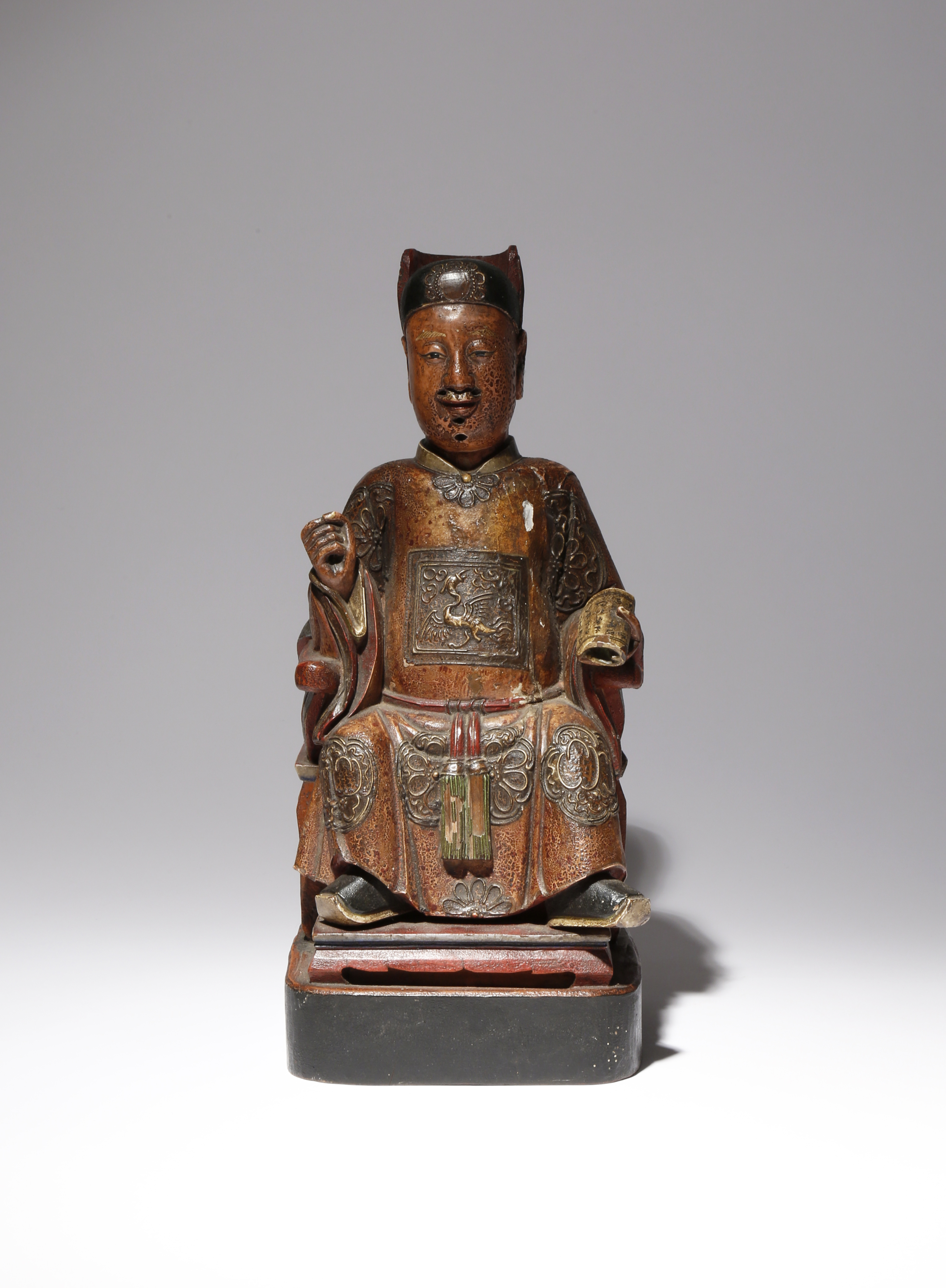 A CHINESE LACQUERED-WOOD FIGURE OF A DIGNITARY QING DYNASTY Carved seated in a chair dressed in