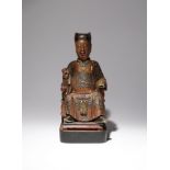 A CHINESE LACQUERED-WOOD FIGURE OF A DIGNITARY QING DYNASTY Carved seated in a chair dressed in