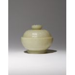 A CHINESE YELLOW JADE 'BAJIXIANG' BOWL AND COVER QING DYNASTY OR LATER Carved as a lotus flowerhead,