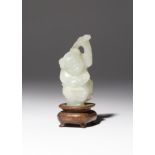 A SMALL CHINESE PALE CELADON JADE CARVING OF A BOY QING DYNASTY The smiling child depicted
