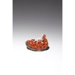 A CHINESE AGATE CARVING OF A SQUIRREL AND GRAPES QING DYNASTY Formed as a bunch of grapes carved