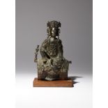 A CHINESE PARCEL-GILT BRONZE FIGURE OF GUANYIN MING DYNASTY She sits in a relaxed pose with her