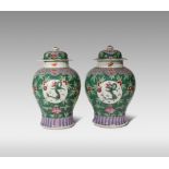 A PAIR OF CHINESE FAMILLE ROSE BALUSTER VASES AND COVERS YONGZHENG/QIANLONG Painted with