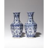A NEAR PAIR OF CHINESE BLUE AND WHITE HEXAGONAL-SECTION VASES LATE QING DYNASTY Painted with
