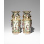 A PAIR OF CHINESE CANTON FAMILLE ROSE HEXAGONAL-SECTION VASES 19TH CENTURY Richly decorated in