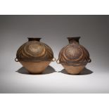 TWO CHINESE POTTERY VASES NEOLITHIC Each surmounted by a waisted neck and tapering towards the foot,