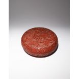 A LARGE CHINESE CINNABAR LACQUER CIRCULAR 'DRAGON' BOX AND COVER 20TH CENTURY The cover carved
