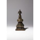 A TIBETAN BRONZE MODEL OF A STUPA 16TH/17TH CENTURY Cast with the bumpa raised on four tiered