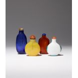 FOUR CHINESE GLASS SNUFF BOTTLES 18TH/19TH CENTURY The largest of a dark blue colour and with a