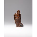 A CHINESE BOXWOOD FIGURE OF MI LE BUDDHA QING DYNASTY Carved standing with his loose robes revealing