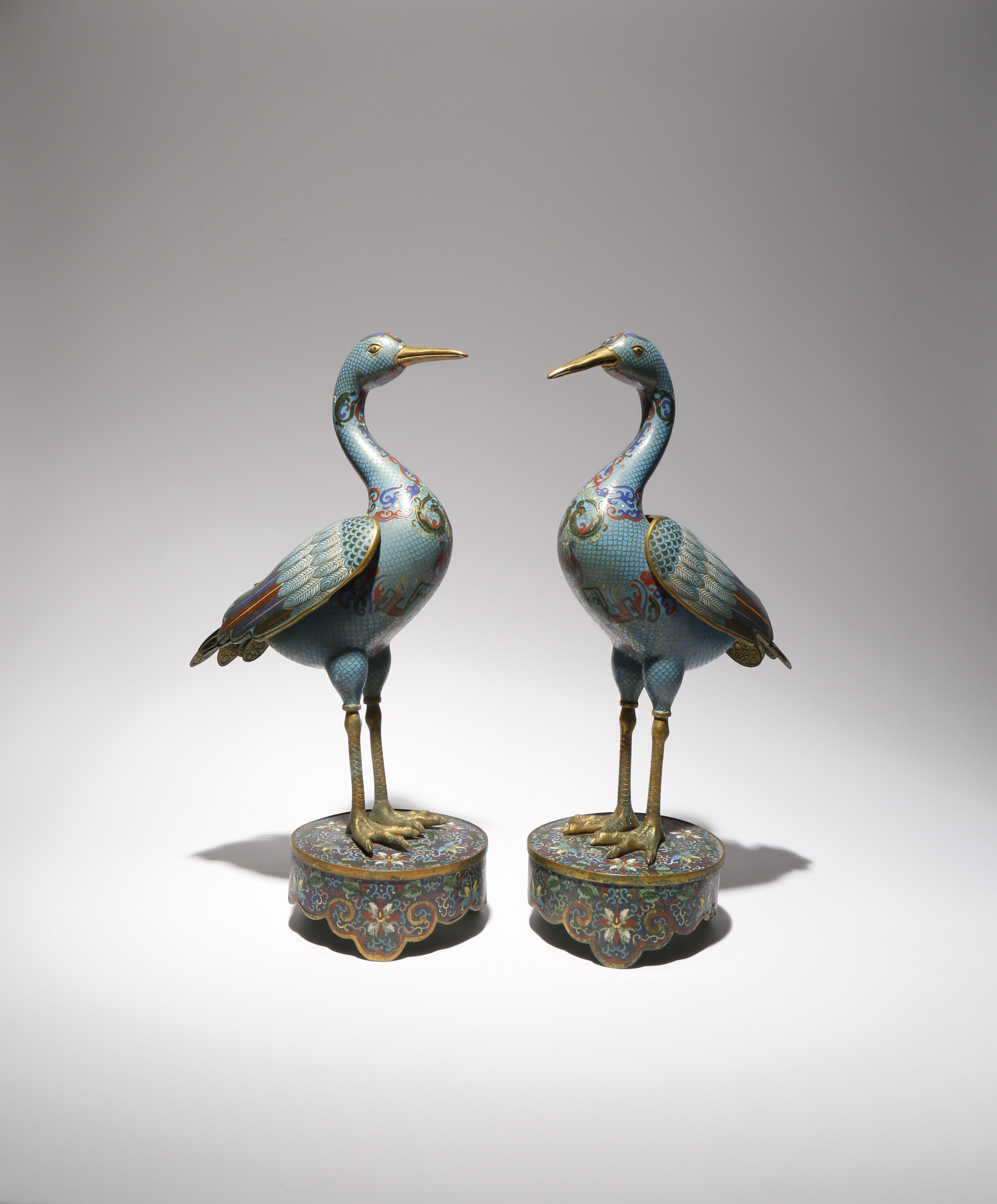 A PAIR OF CHINESE CLOISONNE MODELS OF CRANES C.1900 Each bird stands tall upon a lotus-decorated