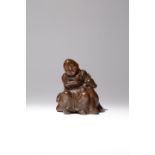 A CHINESE BAMBOO FIGURE OF A LUOHAN AND A DEER QING DYNASTY The figure carved seated upon a