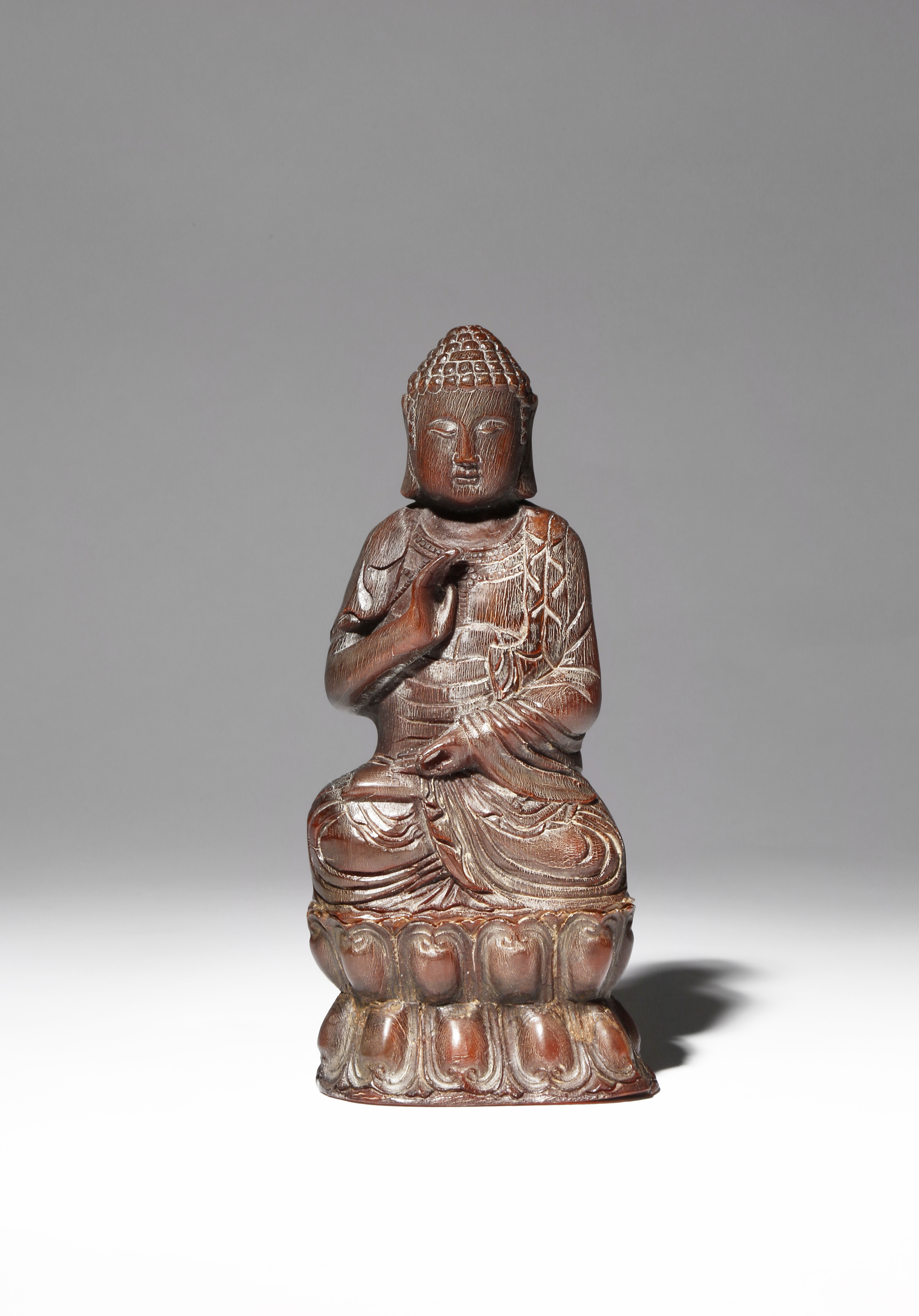 A CHINESE BUFFALO HORN FIGURE OF BUDDHA PROBABLY LATE QING DYNASTY Carved seated in dhyanasana