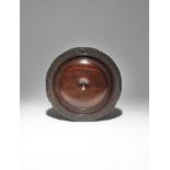 A CHINESE HARDWOOD CIRCULAR STAND 18TH CENTURY Carved with a gently raised dome recessed in the