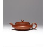 A CHINESE YIXING TEAPOT AND COVER QING DYNASTY The compressed circular body with raised lips