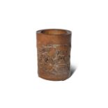 A CHINESE BAMBOO BRUSHPOT, BITONG 18TH/19TH CENTURY Of cylindrical form, carved to one side with a