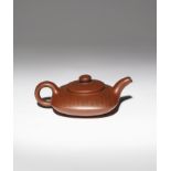 A CHINESE YIXING TEAPOT AND COVER 20TH CENTURY The body formed as a compressed rounded square, set