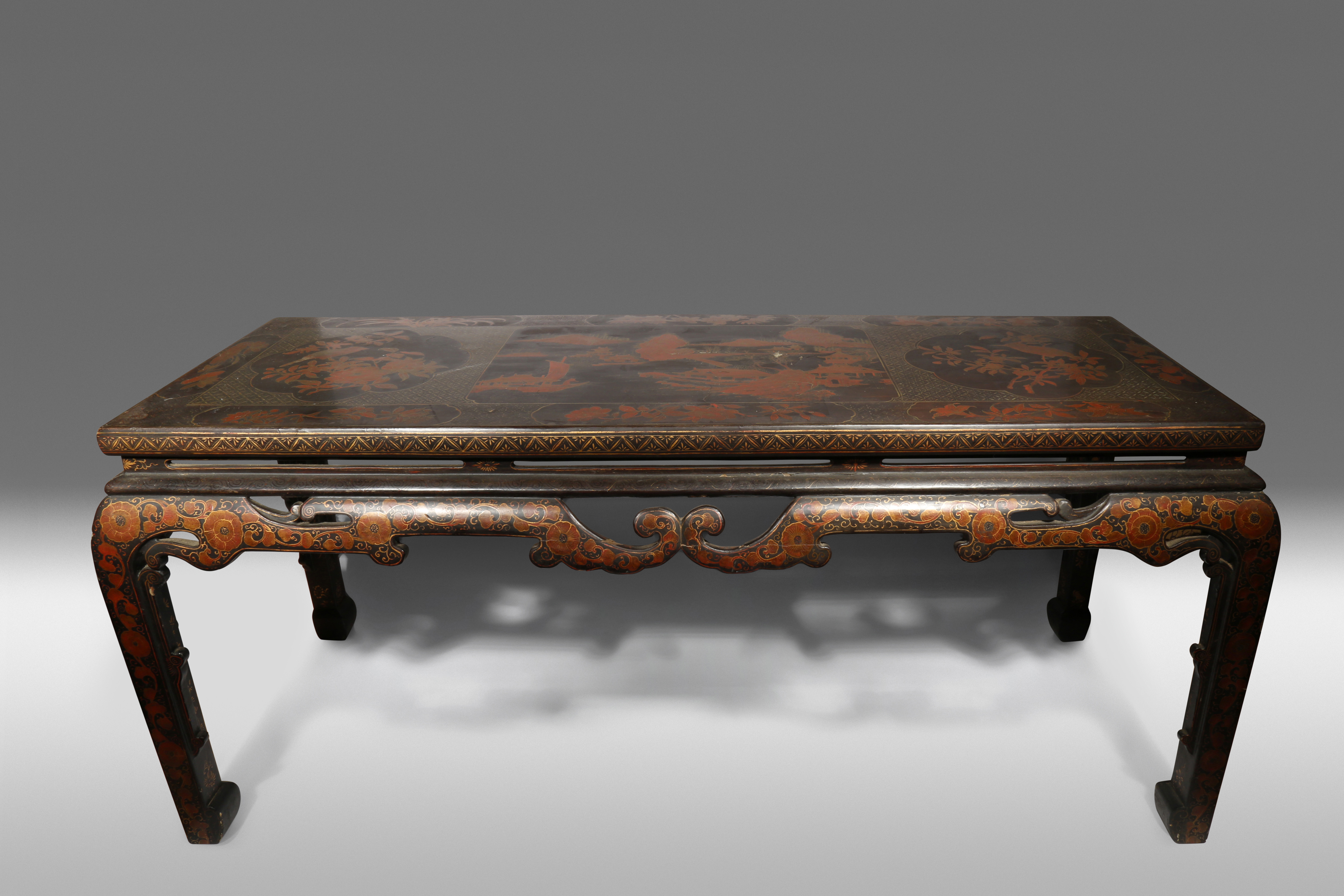 A CHINESE LACQUER TABLE 19TH CENTURY The rectangular top decorated in gold and red lacquer with a