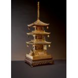 A JAPANESE KOMAI STYLE IRON MODEL OF A THREE-TIERED PAGODA MEIJI PERIOD, 19TH OR 20TH CENTURY Richly