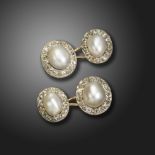 A pair of French pearl and diamond cluster cufflinks, each pearl is set within a surround of