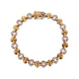 A diamond-set two colour gold bracelet, alternately set with gold disc links and diamond-set