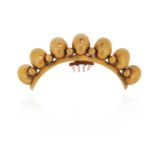 λ A mid 19th century gilt metal hair ornament, the graduated seven ovoids alternately-set with