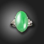 A jade and diamond ring, the green jadeite jade cabochon set with a trefoil of old circular-cut