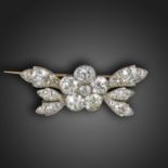 A Victorian flowerhead brooch, set overall with graduated old circular-cut diamonds in silver and