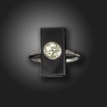 An onyx and diamond plaque ring, the rectangular-shaped onyx is centred with an old circular-cut