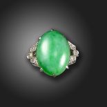 A jade and diamond ring, the green jadeite jade cabochon is set with single-cut diamonds to the