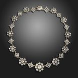A late Victorian diamond necklace, set with graduated clusters of old cushion-shaped diamonds in