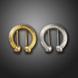 A pair of platinum and gold brooches by Mellerio, each stylised horseshoe with chevron engraving and
