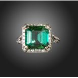 An Art Deco tourmaline and diamond cluster ring, the Asscher-cut tourmaline is set within a surround