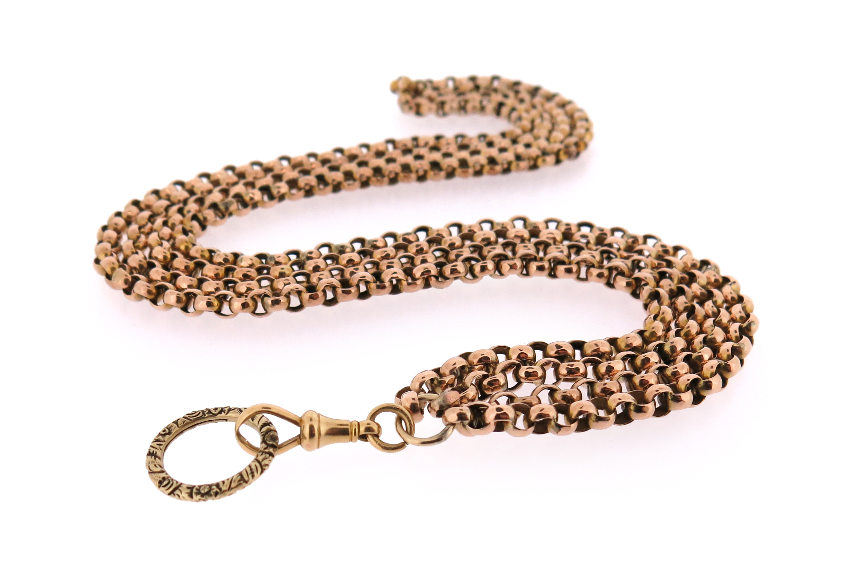 A two-row gold longuard chain, the plain gold links with a Regency split ring with foliate