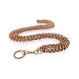 A two-row gold longuard chain, the plain gold links with a Regency split ring with foliate